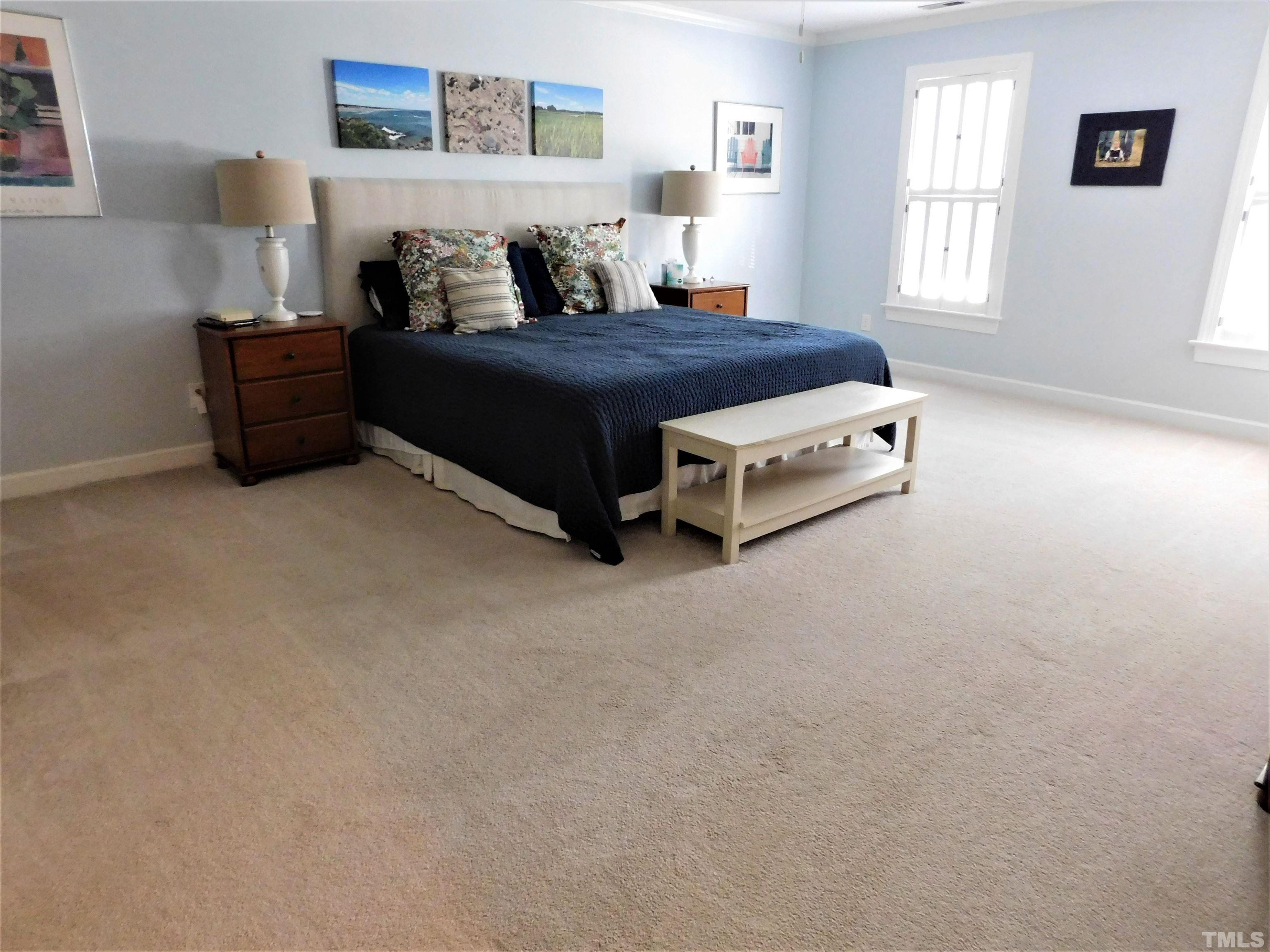 11417 Pacesferry Drive Raleigh, NC 27614 - Photo 21 of 39 a bed sitting in a bedroom next to a window with a bookshelf