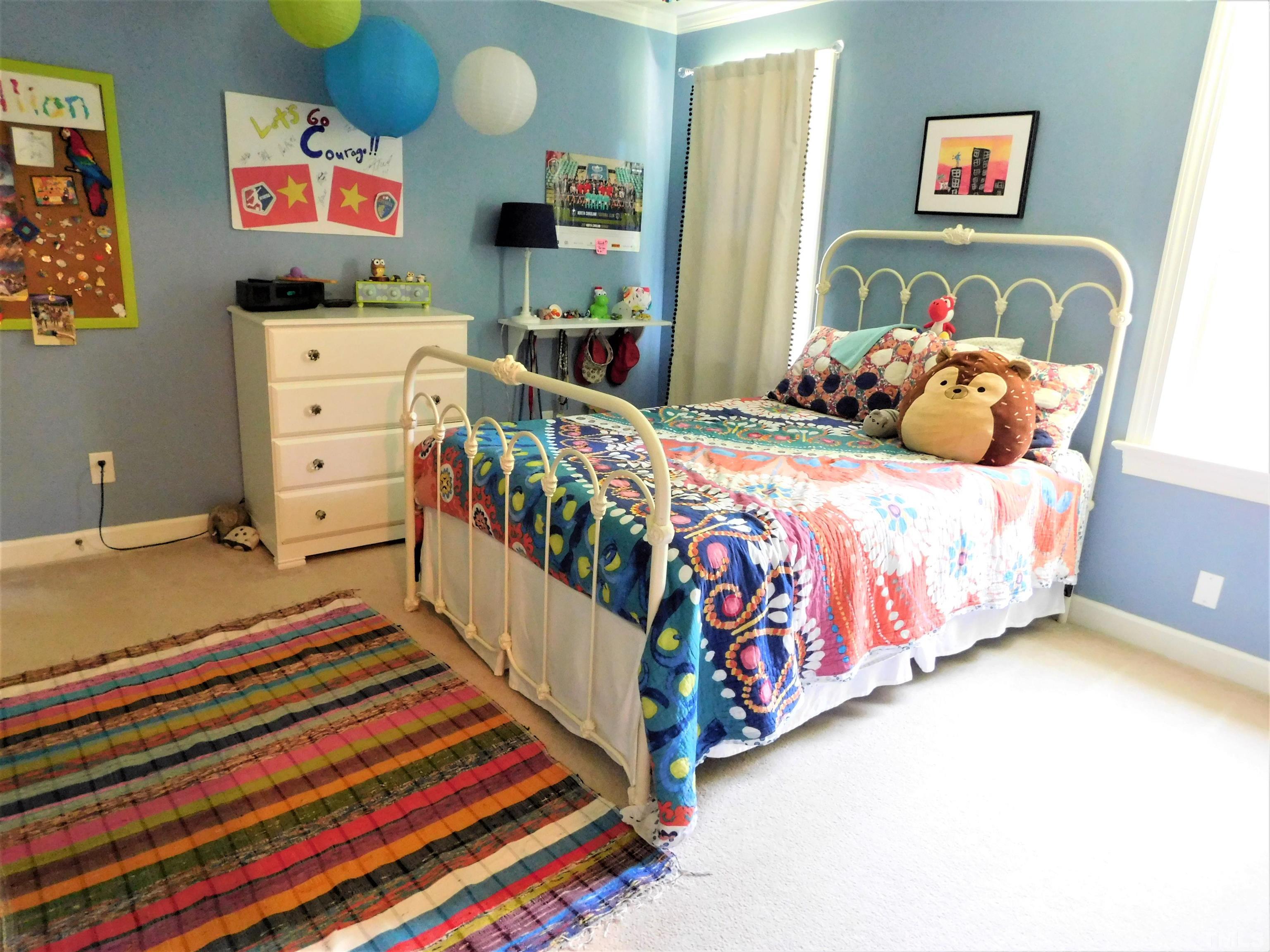11417 Pacesferry Drive Raleigh, NC 27614 - Photo 22 of 39 a bedroom with bed and wooden floor
