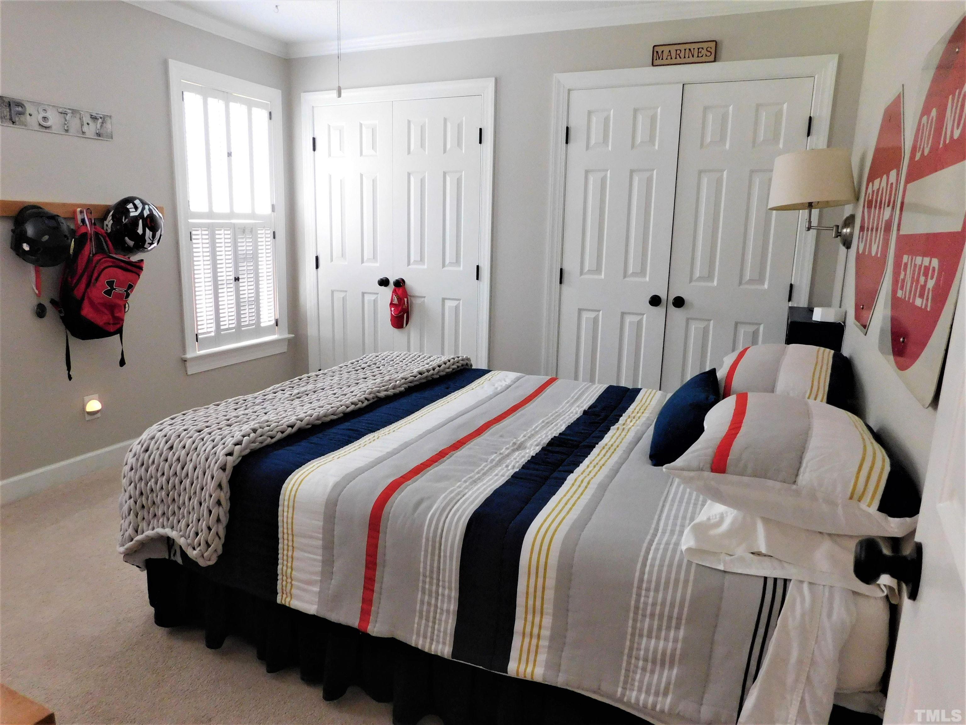 11417 Pacesferry Drive Raleigh, NC 27614 - Photo 24 of 39 a bedroom with a bed and a window