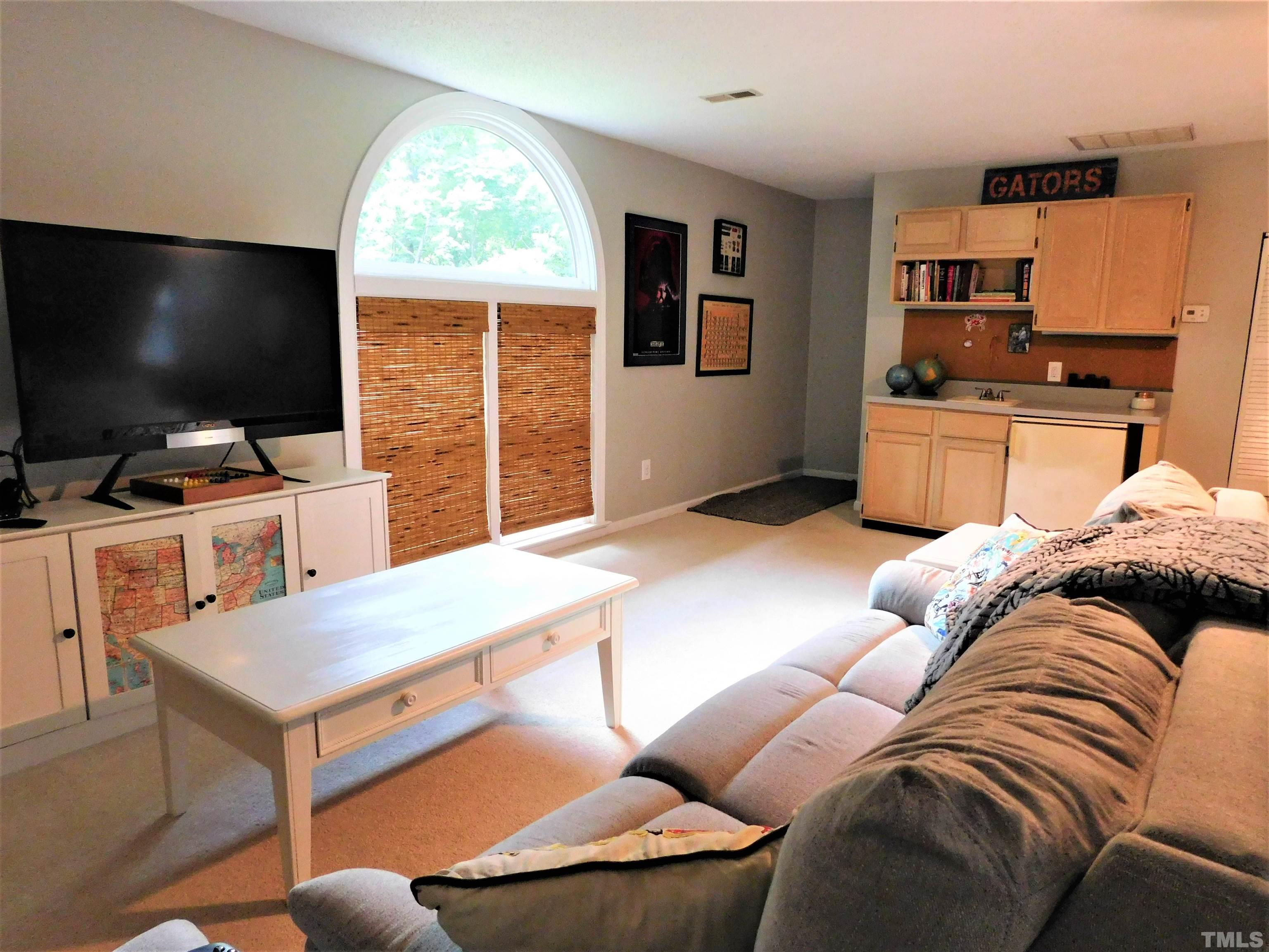 11417 Pacesferry Drive Raleigh, NC 27614 - Photo 28 of 39 a living room with furniture and a flat screen tv