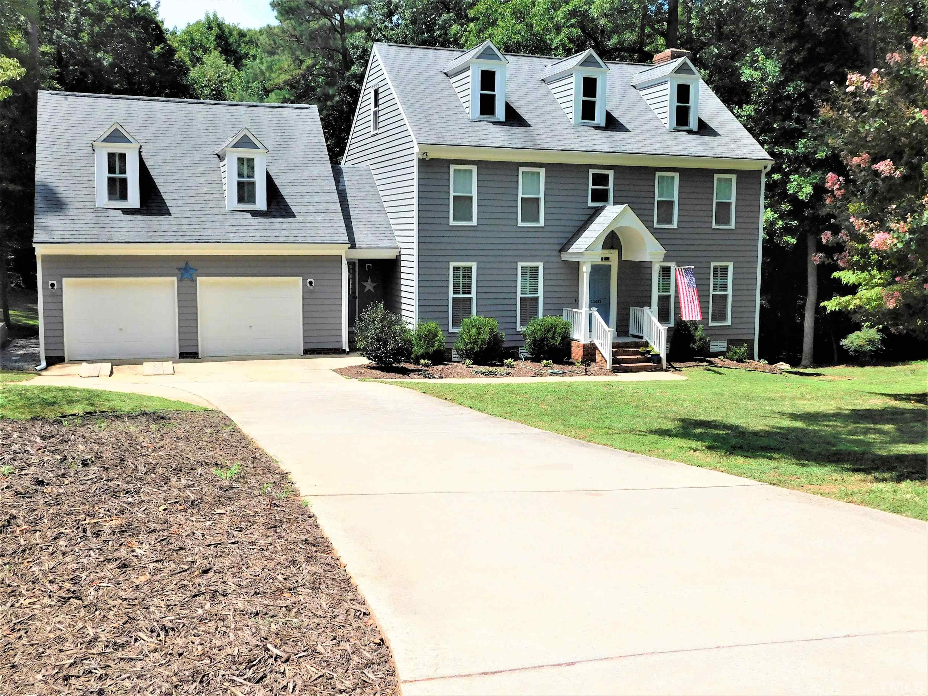 11417 Pacesferry Drive Raleigh, NC 27614 - Photo 3 of 39 a front view of a house with a yard