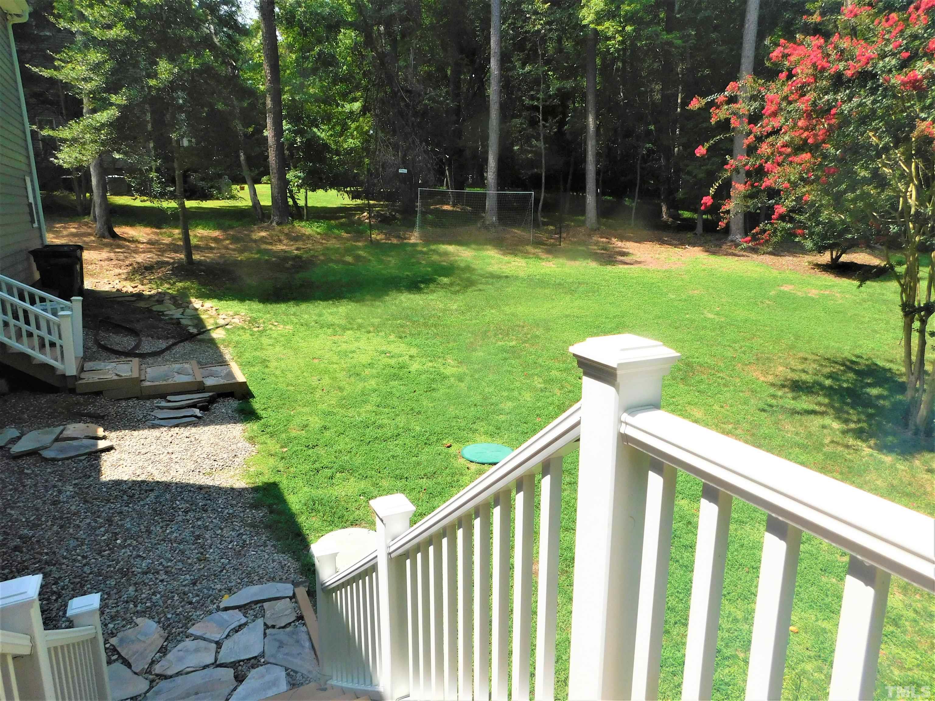 11417 Pacesferry Drive Raleigh, NC 27614 - Photo 9 of 39 a view of a wooden fence and a yard