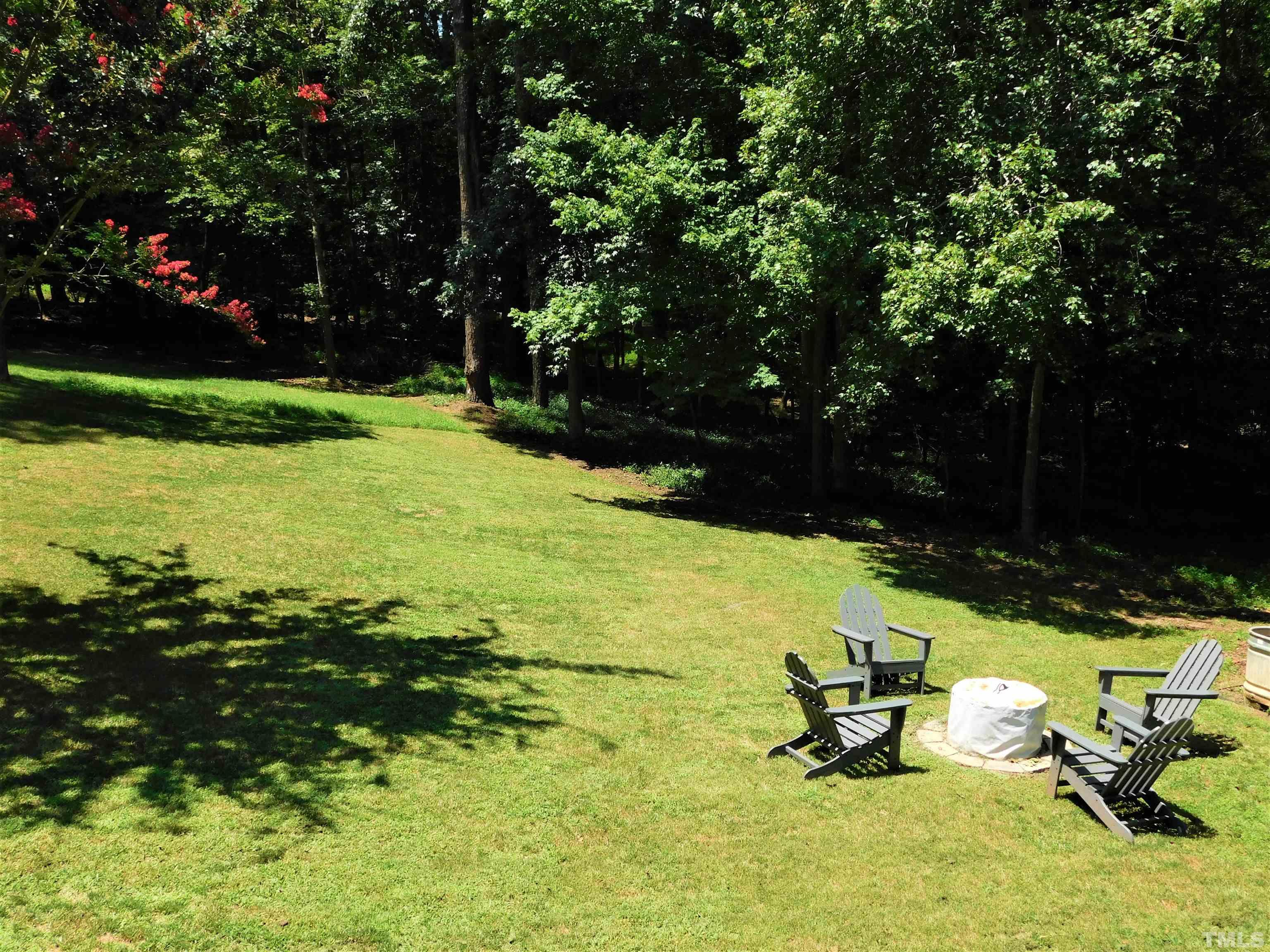 11417 Pacesferry Drive Raleigh, NC 27614 - Photo 10 of 39 a view of a swimming pool with lawn chairs and a yard