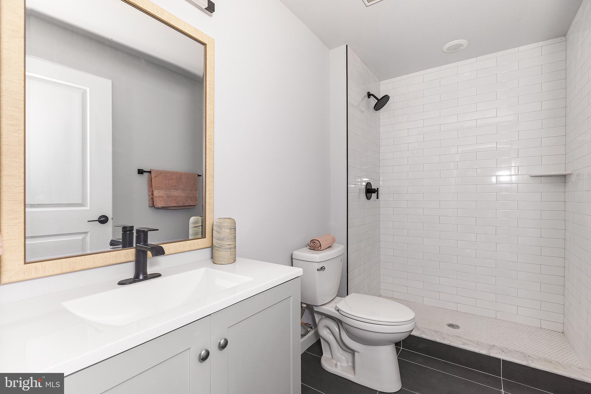 5542-44 Ridge Avenue, Unit 314 Philadelphia, PA 19128 - Photo 12 of 19 a bathroom with a sink toilet and shower