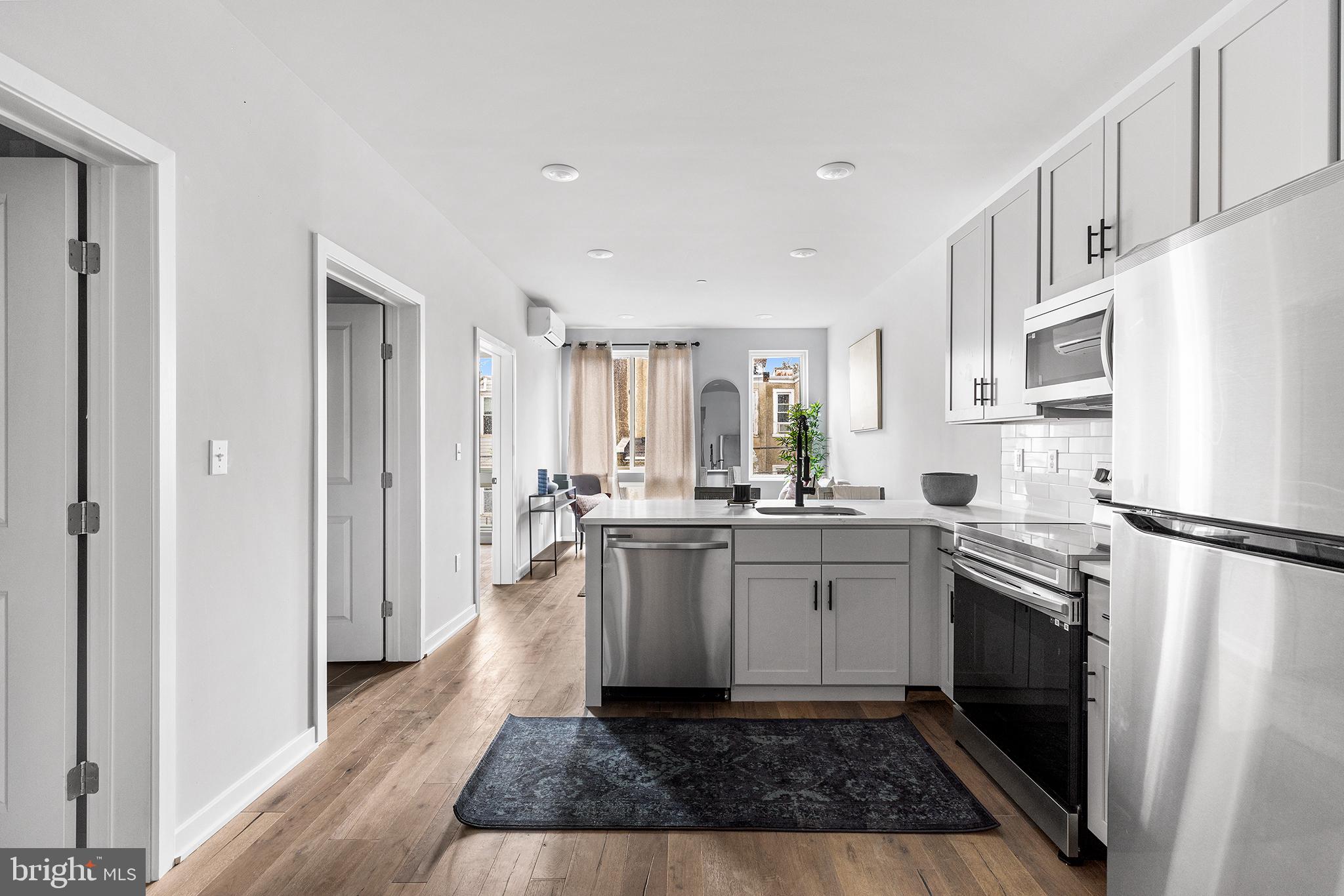 5542-44 Ridge Avenue, Unit 314 Philadelphia, PA 19128 - Photo 2 of 19 a kitchen with white cabinets and white appliances