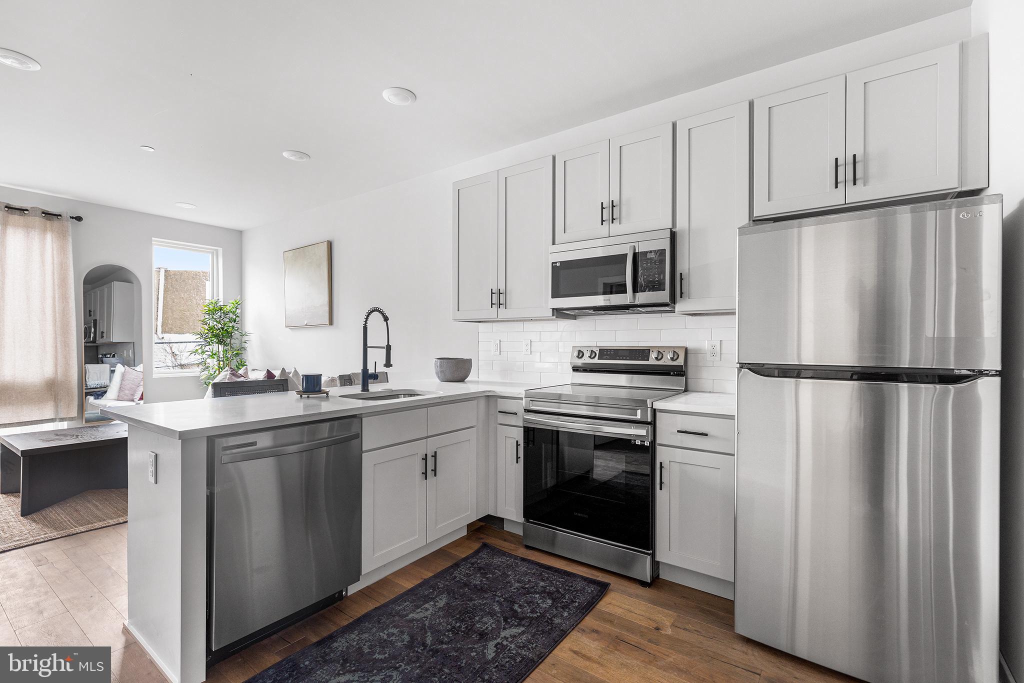 5542-44 Ridge Avenue, Unit 314 Philadelphia, PA 19128 - Photo 4 of 19 a kitchen with a sink stove and refrigerator