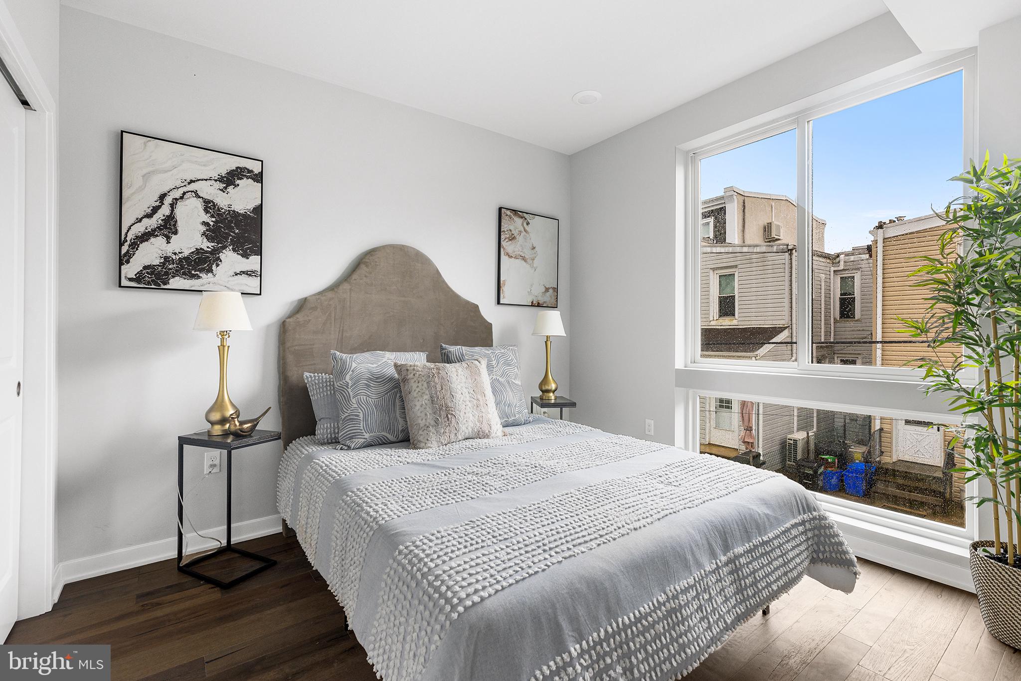 5542-44 Ridge Avenue, Unit 314 Philadelphia, PA 19128 - Photo 10 of 19 a bedroom with a large bed and a chandelier