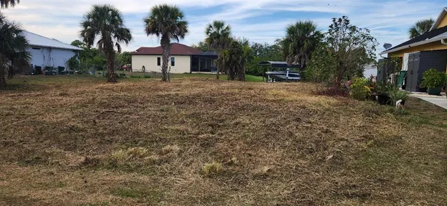 a backyard of a house with table and chairs