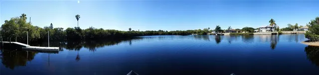 a view of yard with large tree and wooden fence