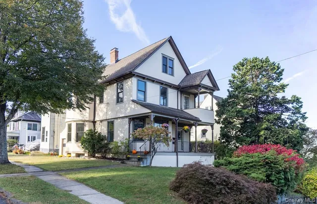 a front view of a house with a yard table and chairs