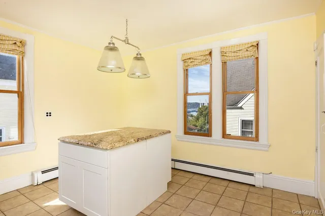 a bathroom with a granite countertop sink and a window