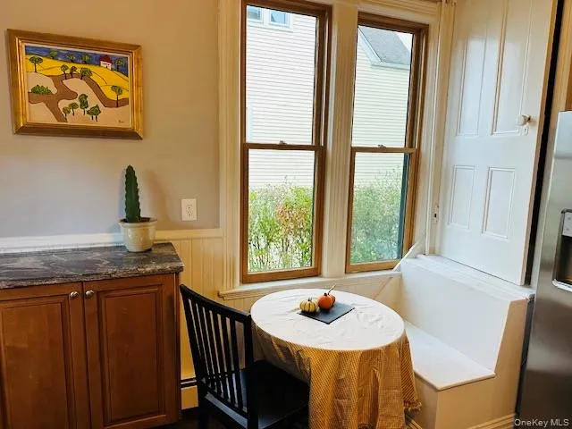 a dining room with furniture and window