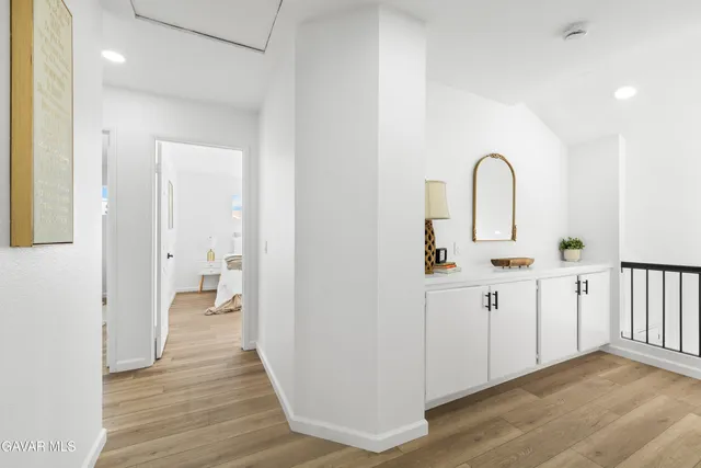 a spacious bedroom with a bed and a chandelier