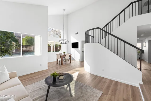 a living room with furniture and a dining table