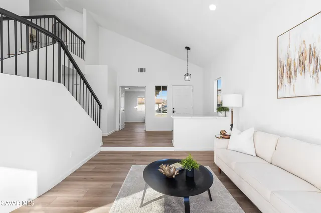 a living room with furniture and a chandelier
