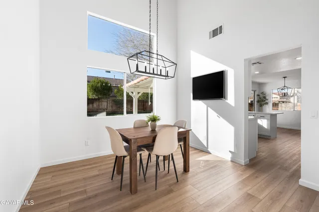 a view of a dining room with furniture wooden floor and chandelier