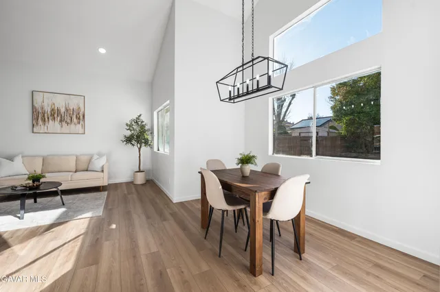 a view of a dining room with furniture wooden floor and chandelier