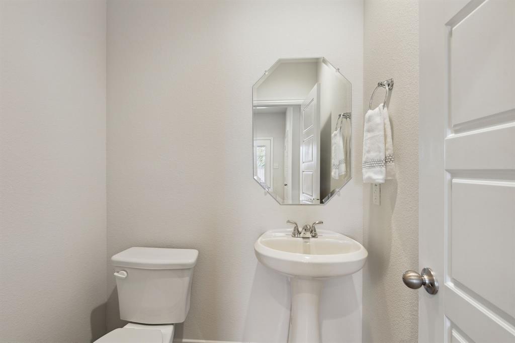 6028 Bursey Road Watauga, TX 76148 - Photo 12 of 27 a bathroom with a toilet sink and mirror