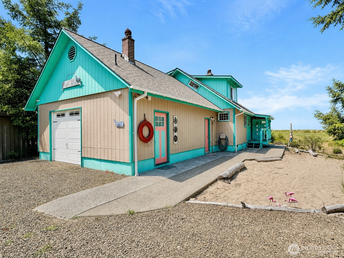 15217 Pacific Way Long Beach, WA 98631 - Photo 2 of 40 a front view of a house with a yard and garage