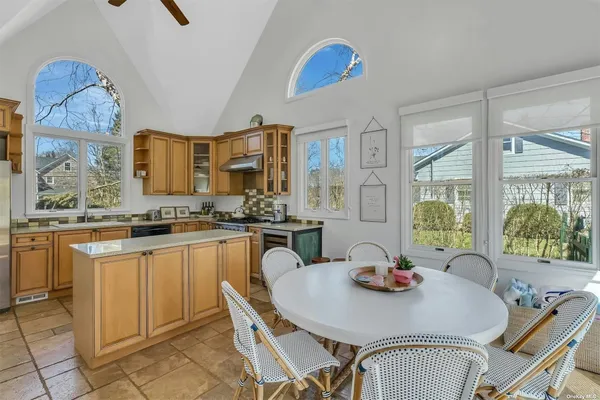 a view of a dining room with furniture a chandelier and wooden floor
