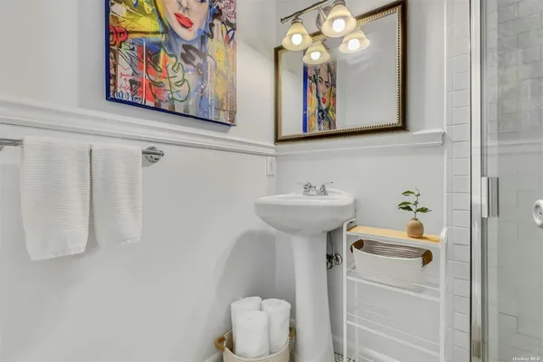 a bathroom with a sink mirror and toilet