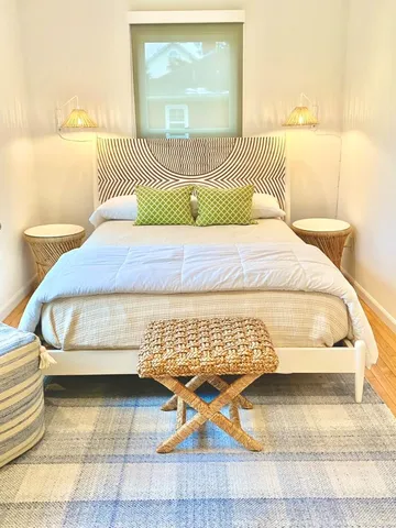 a bathroom with a toilet and a chair