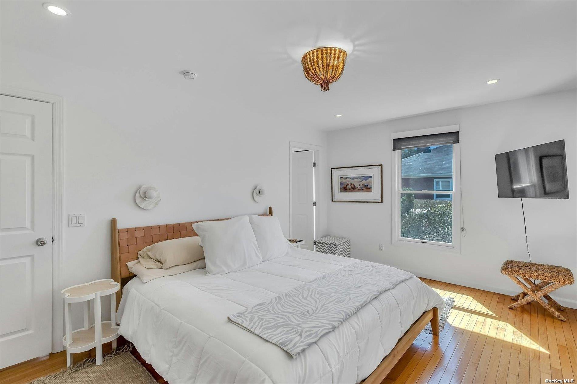 6 Nidzyn Avenue Remsenburg, NY 11960 - Photo 15 of 31 a bedroom with a bed and a cabinets