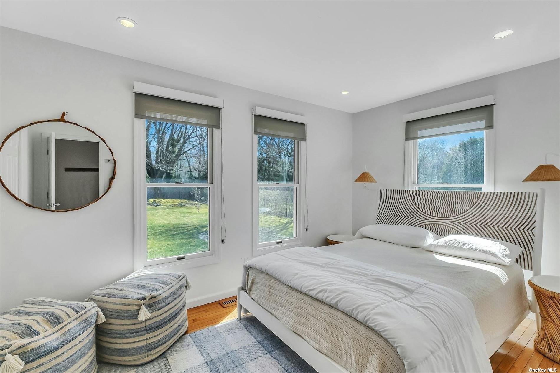 6 Nidzyn Avenue Remsenburg, NY 11960 - Photo 17 of 31 a bedroom with a bed and a mirror