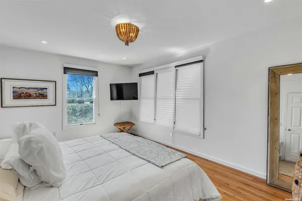 a bedroom with a bed and a large window