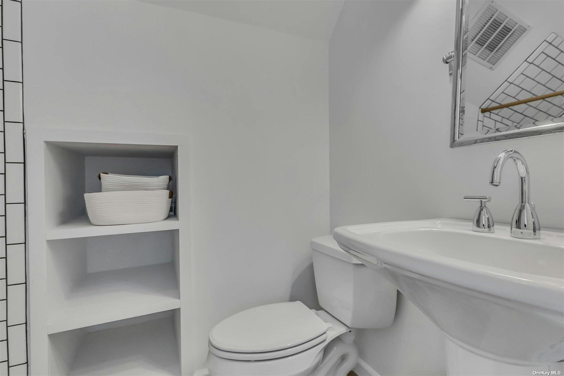 6 Nidzyn Avenue Remsenburg, NY 11960 - Photo 20 of 31 a bathroom with a toilet a sink and mirror