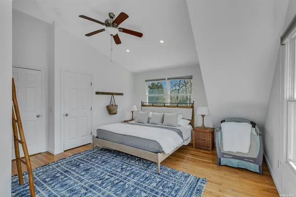 a bedroom with a bed and a mirror
