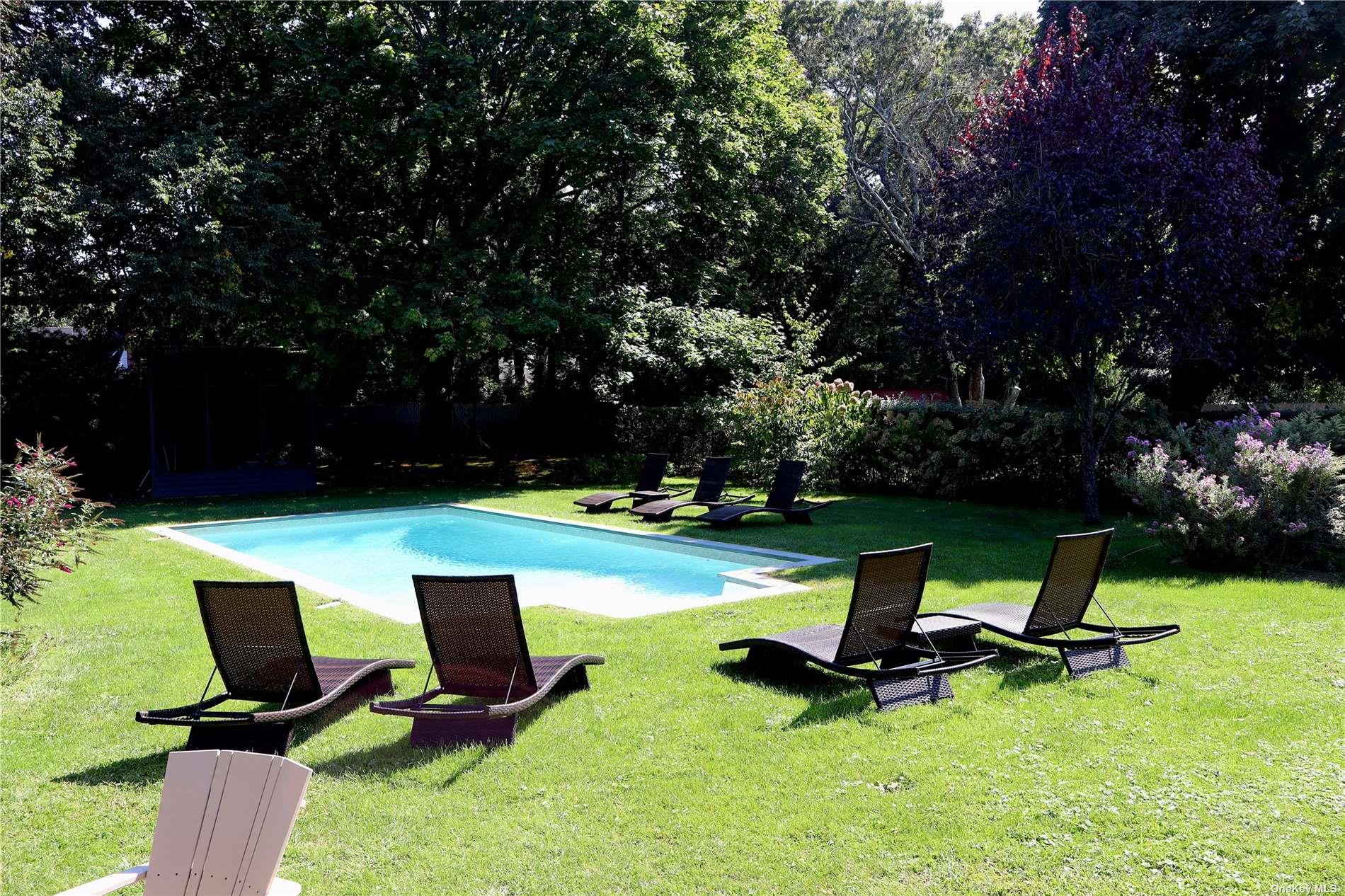 6 Nidzyn Avenue Remsenburg, NY 11960 - Photo 27 of 31 a view of a backyard with a table and chairs