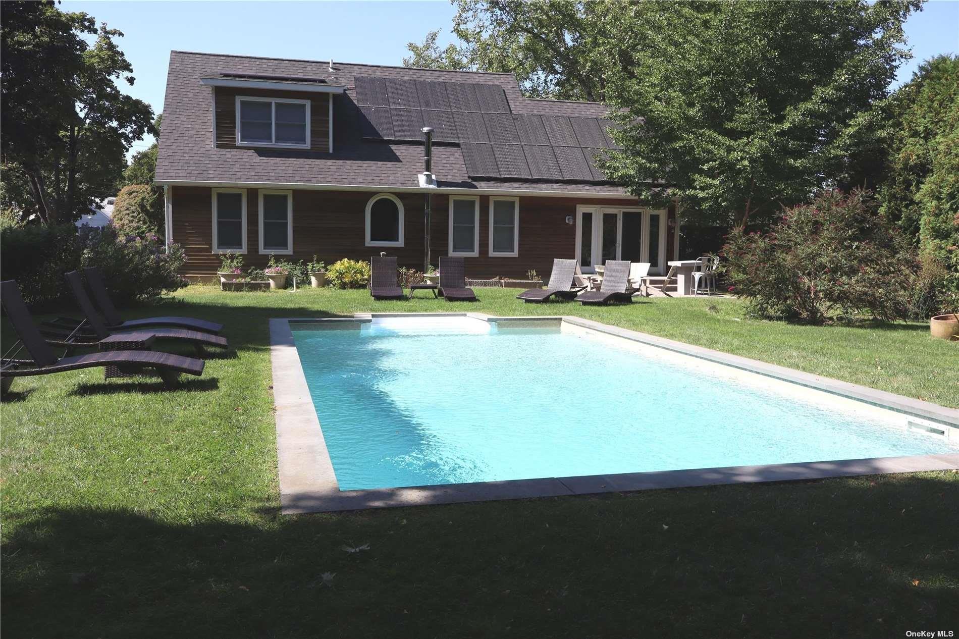 6 Nidzyn Avenue Remsenburg, NY 11960 - Photo 31 of 31 a front view of a house with swimming pool having outdoor seating