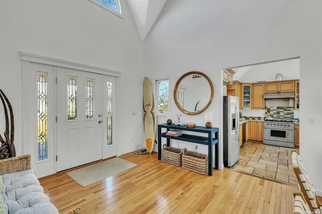 a living room with furniture a mirror and a flat screen tv