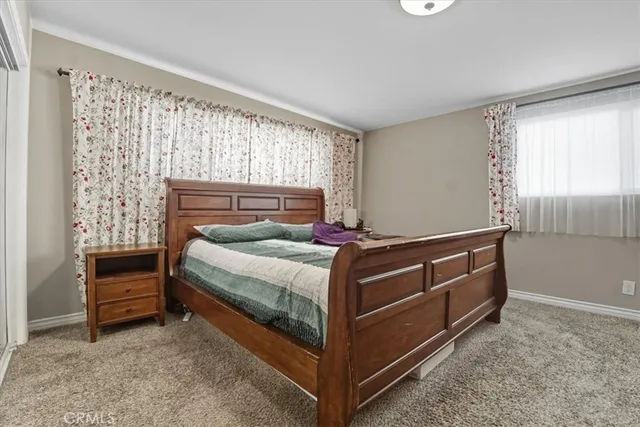 a bed sitting in a room next to a window