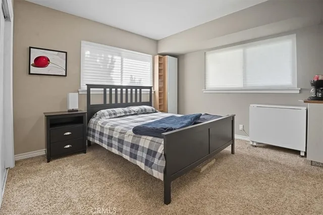 a bed sitting in a bedroom next to a window