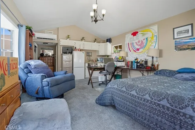 a living room with furniture piano and a chandelier