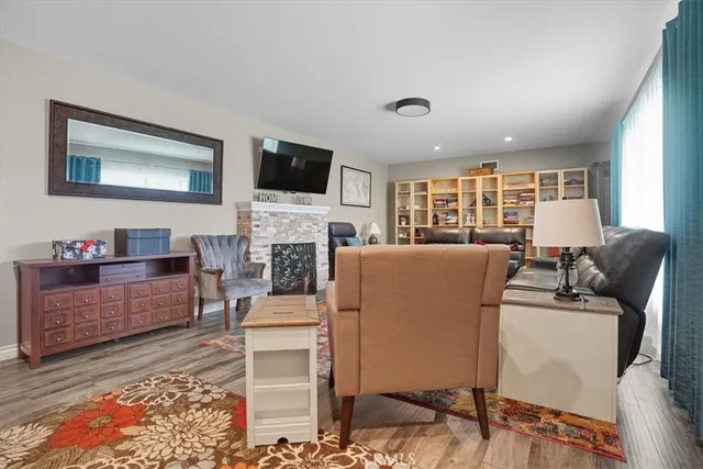 a living room with furniture a flat screen tv and a fireplace