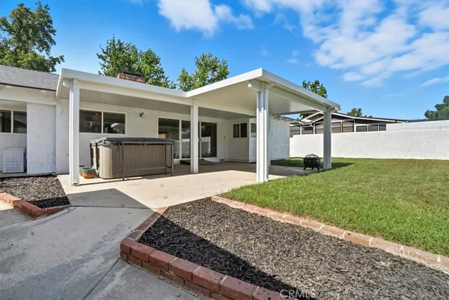 a front view of a house with a garden and yard