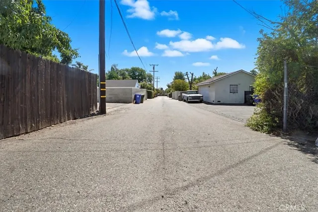 a view of a house with wooden fence