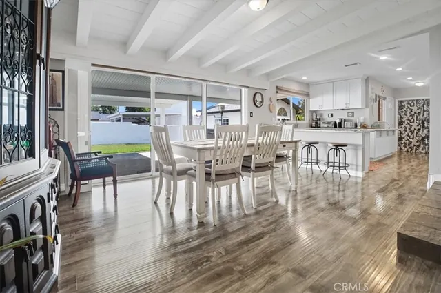 a dining room with furniture wooden floor and a rug
