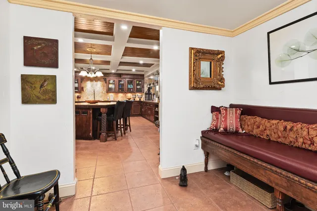 a living room with furniture and painting on the wall