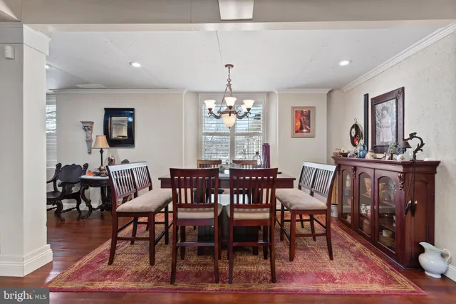 a view of a a dining room with furniture window and wooden floor