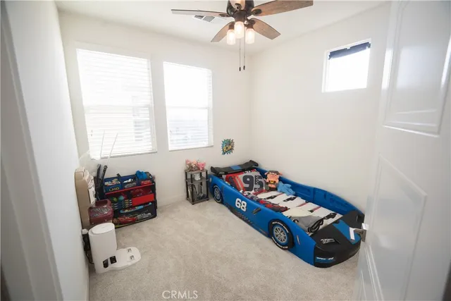 a bedroom with furniture and a window