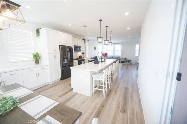 a bedroom with a bed a flat screen tv and a large window