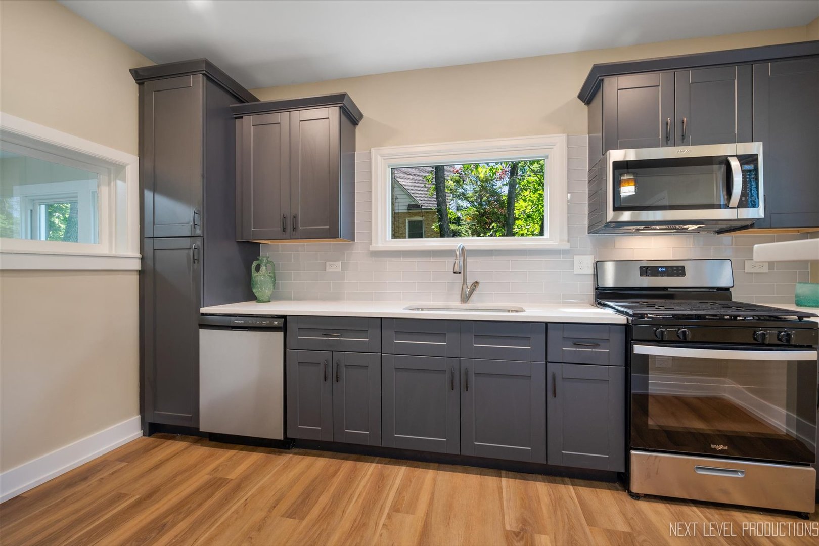 201 South Gilbert Street South Elgin, IL 60177 - Photo 9 of 27 a kitchen with stainless steel appliances a stove a sink and a microwave