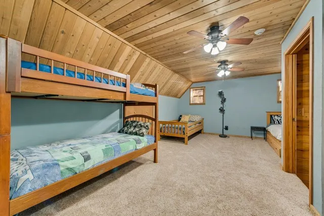 a bedroom with bed and a chandelier