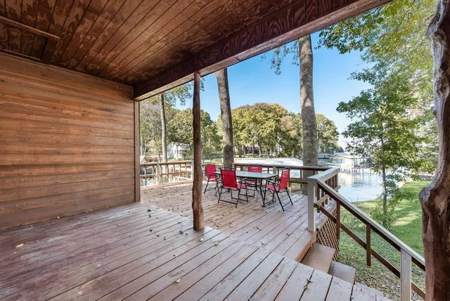 a view of a deck with wooden floor and outdoor seating