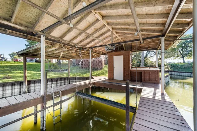 a view of a lake with lawn chairs