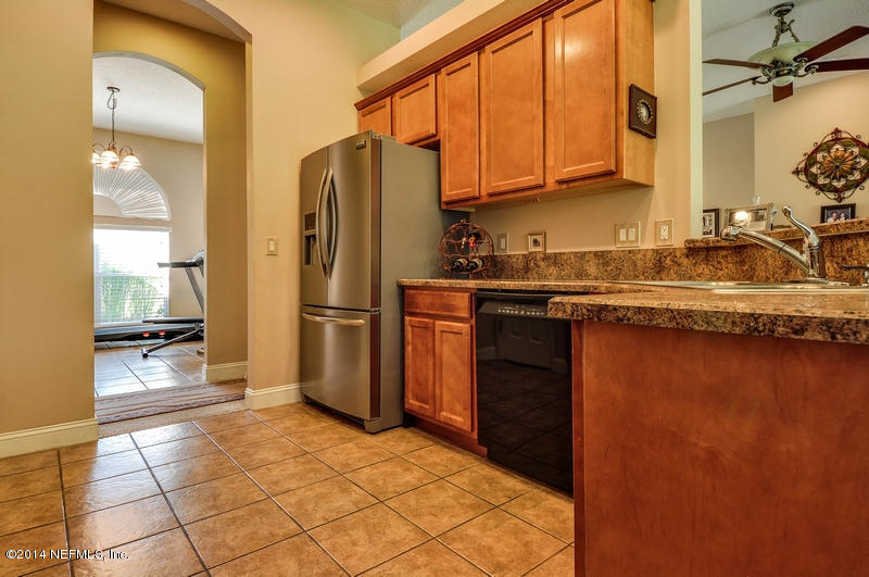 55108 Bear Run Road Callahan, FL 32011 - Photo 11 of 33 a kitchen with stainless steel appliances granite countertop a refrigerator a stove and a sink